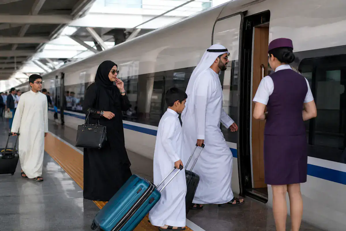 Gulf family boarding a Chinese high speed train with a coordinator