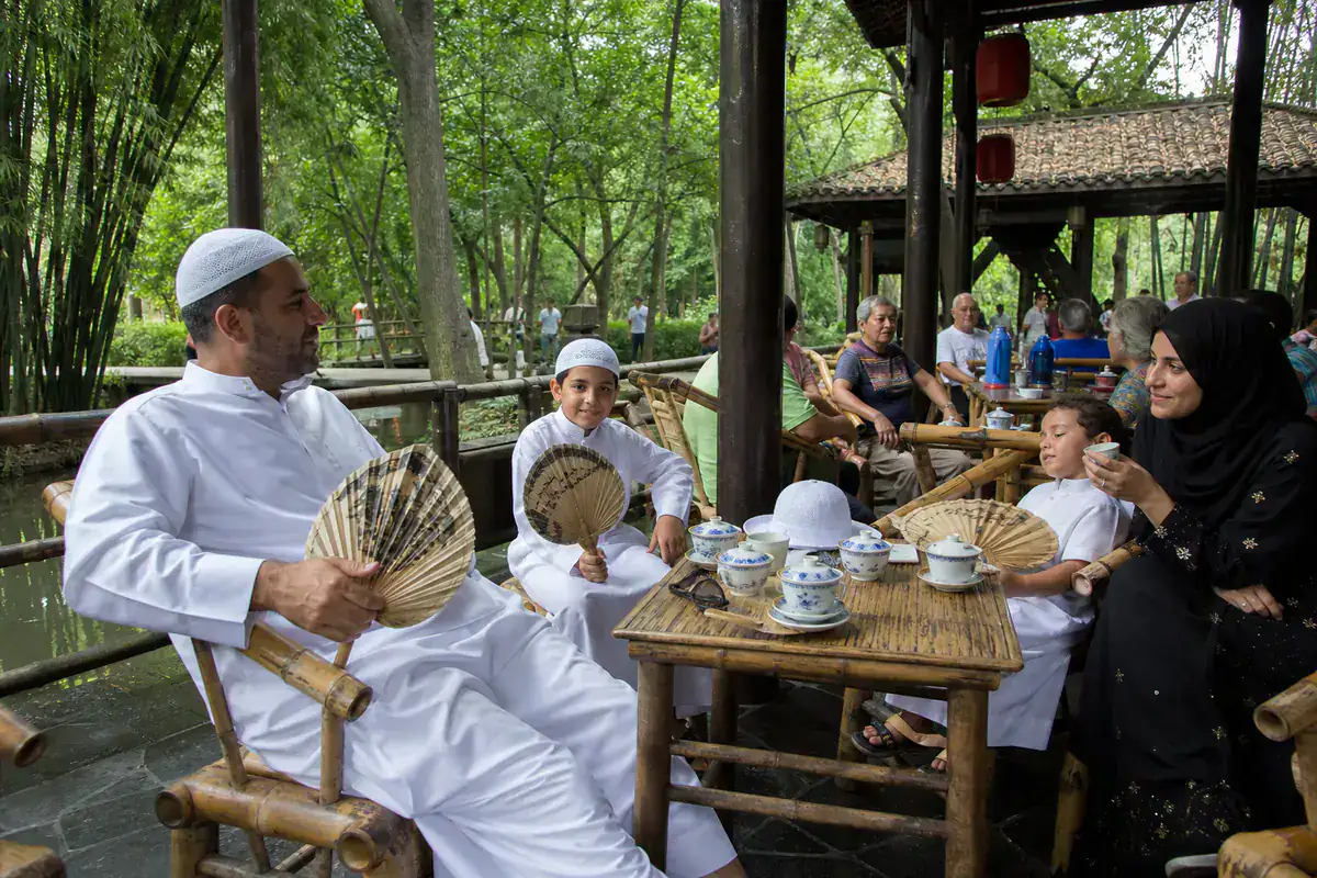 Gulf family resting in a shaded Chengdu tea house