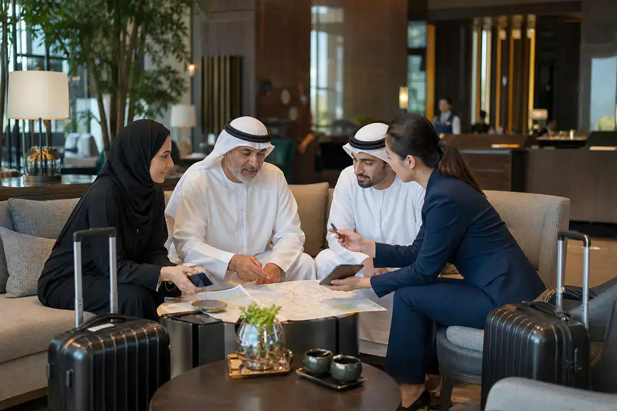 UAE travelers planning a private China route with a coordinator in a hotel lounge