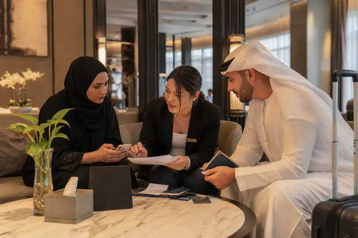 UAE couple checking passport and arrival documents with a Chinese coordinator