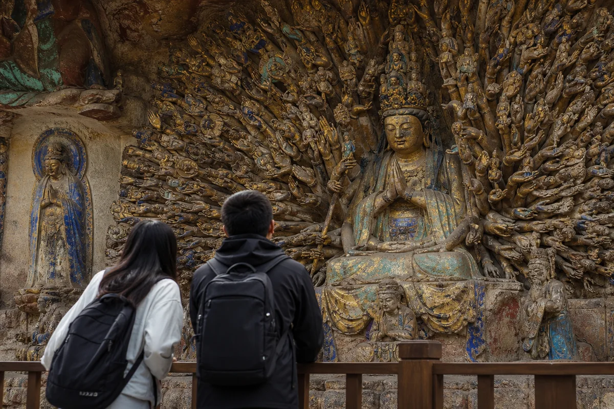 Travelers studying the Thousand Armed Guanyin carving at Dazu