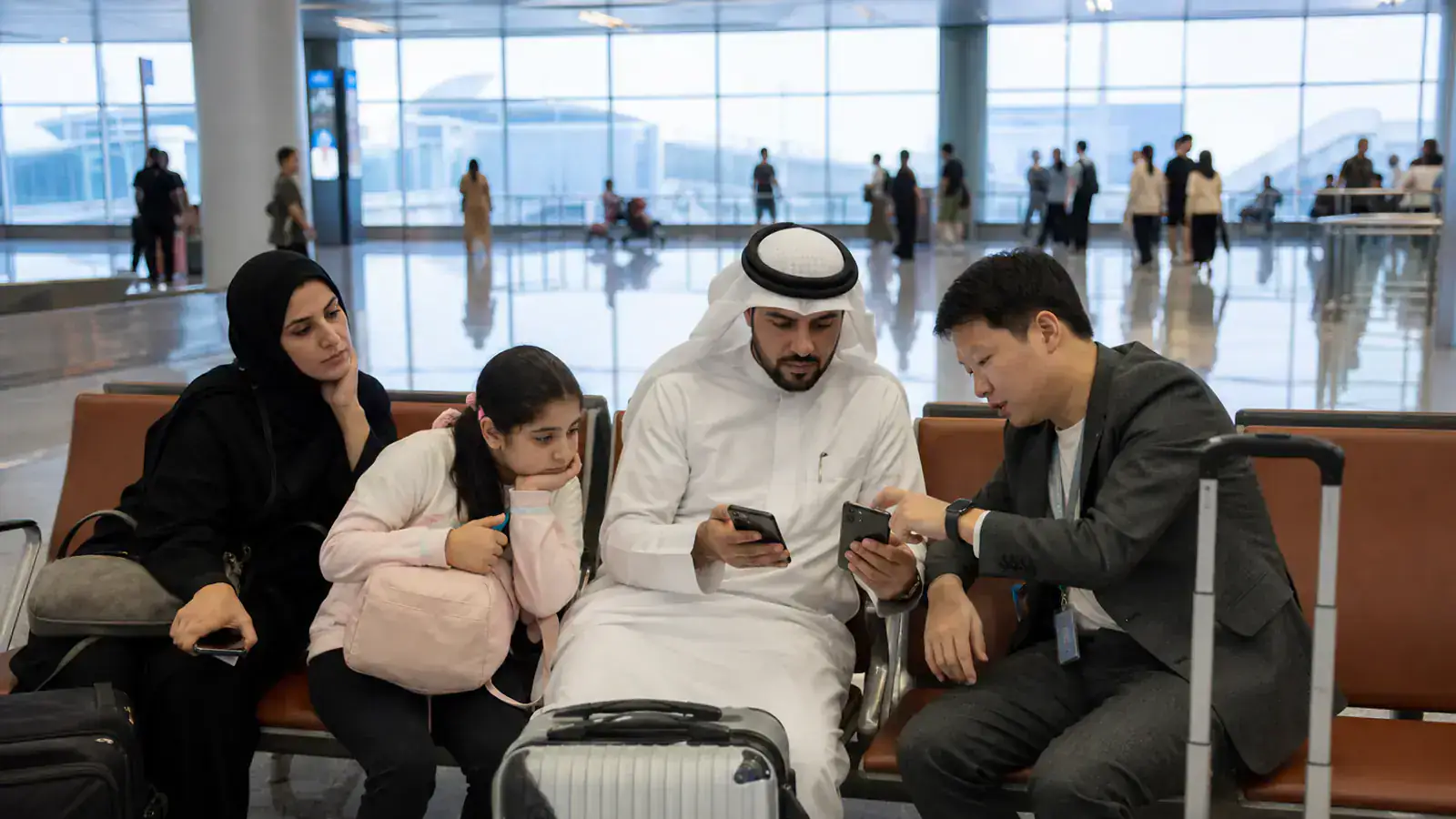 Gulf family setting up payment and connectivity with a coordinator after landing in Shanghai