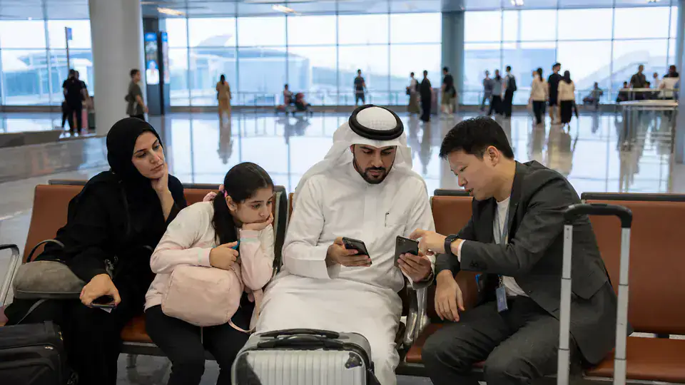 Gulf family setting up payment and connectivity with a coordinator after landing in Shanghai