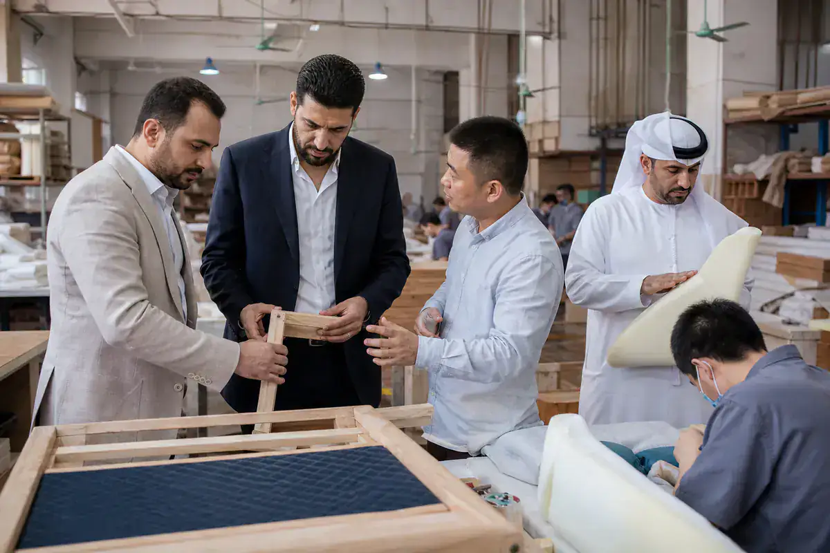 UAE buyers inspecting furniture construction inside a Foshan workshop