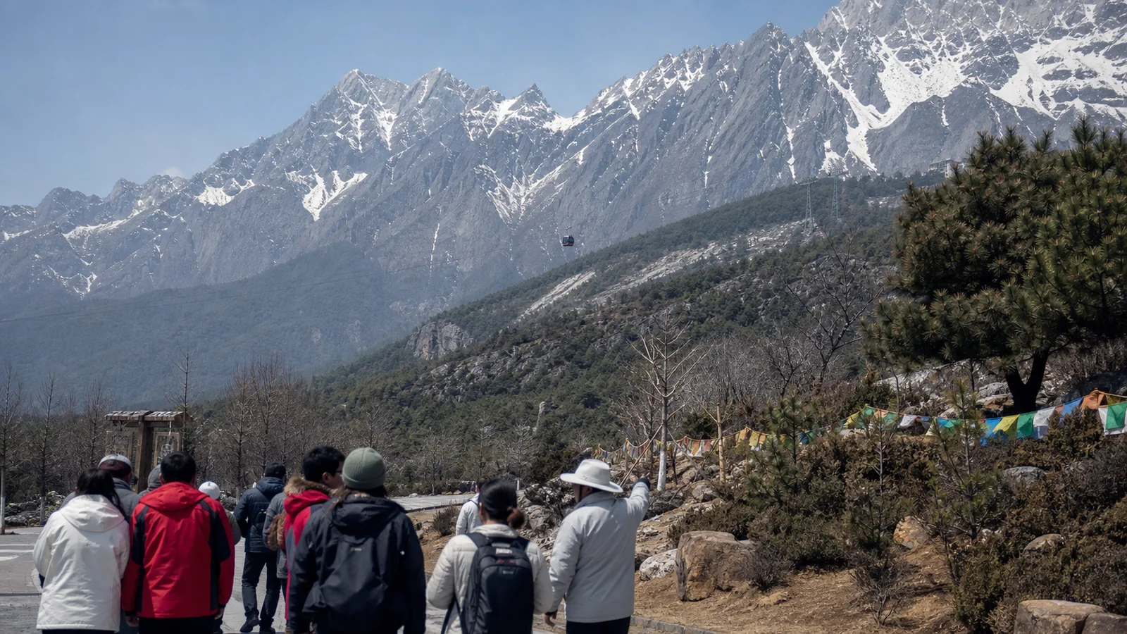 Travelers approaching Jade Dragon Snow Mountain near Lijiang