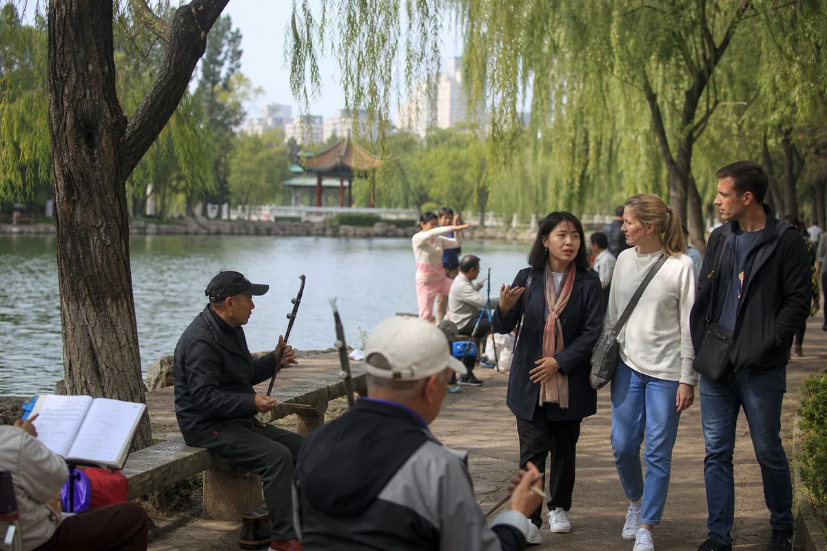 International travelers walking through Green Lake Park in Kunming with a local guide
