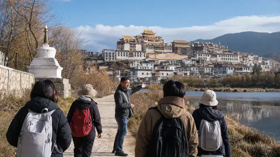 Private vehicle stopped at a mountain viewpoint on the road from Lijiang to Shangri La