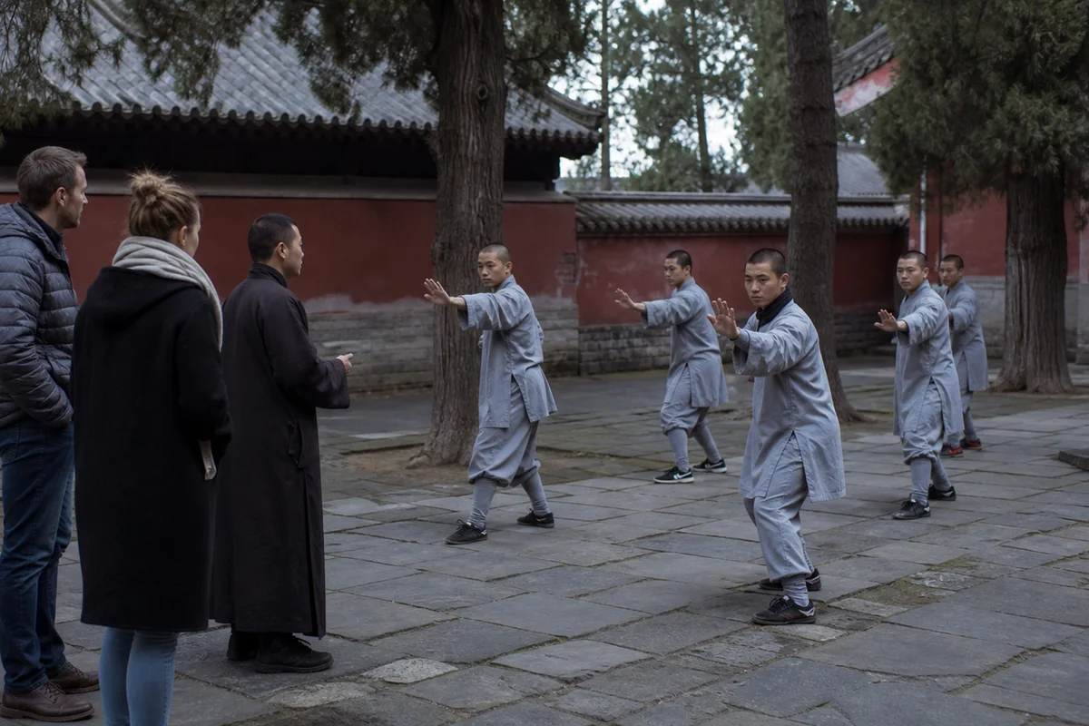 Shaolin students practicing quietly in a historic Songshan temple courtyard