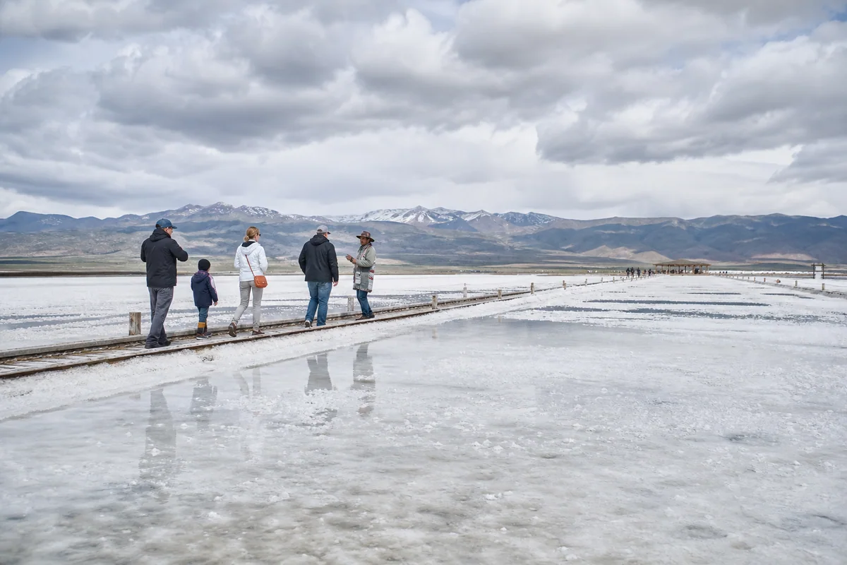 Family and local guide using a designated boardwalk at Chaka Salt Lake