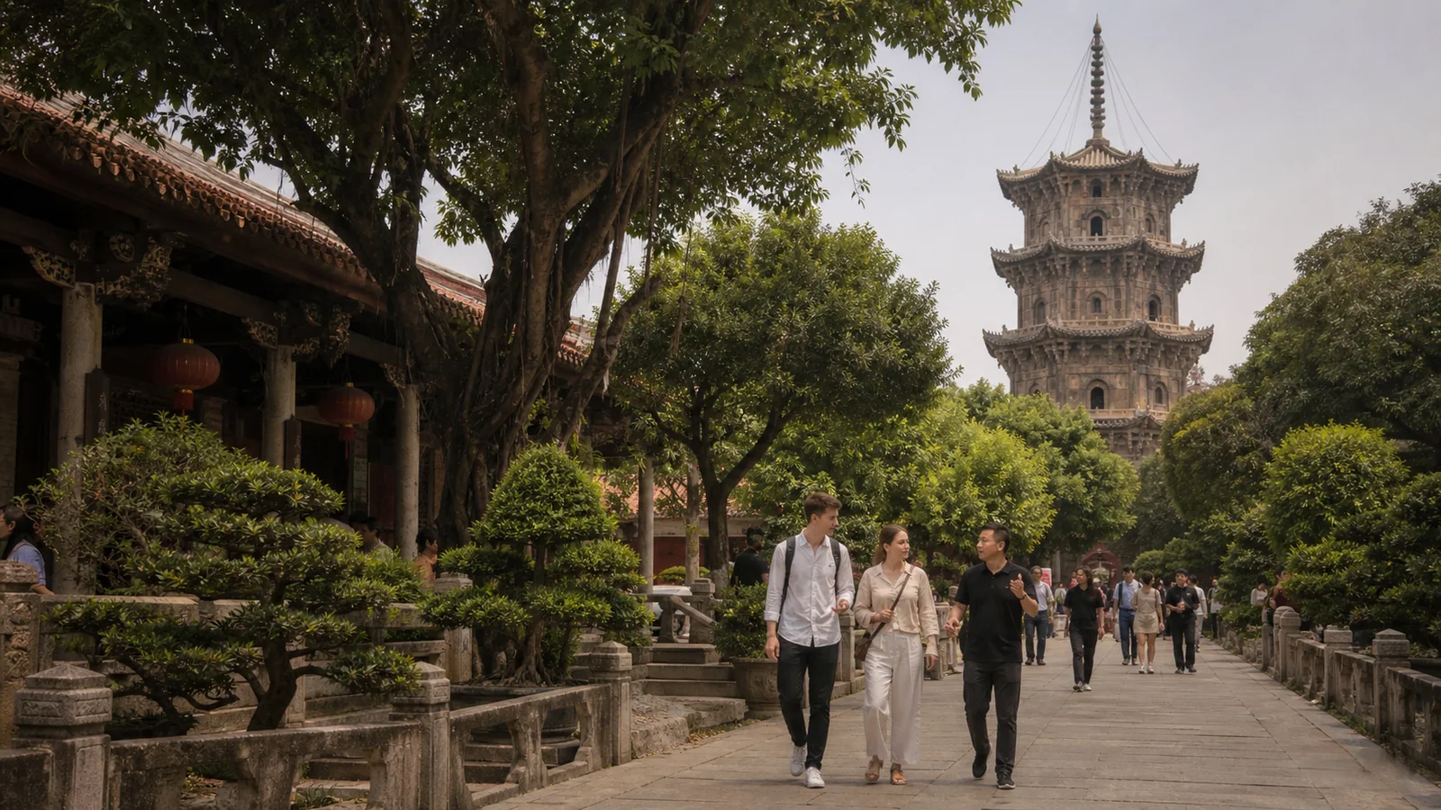 Travelers walking through Kaiyuan Temple in Quanzhou with a stone pagoda behind them