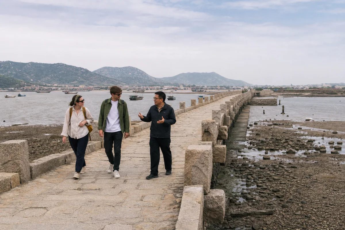Travelers crossing historic Luoyang Bridge near Quanzhou with a private guide