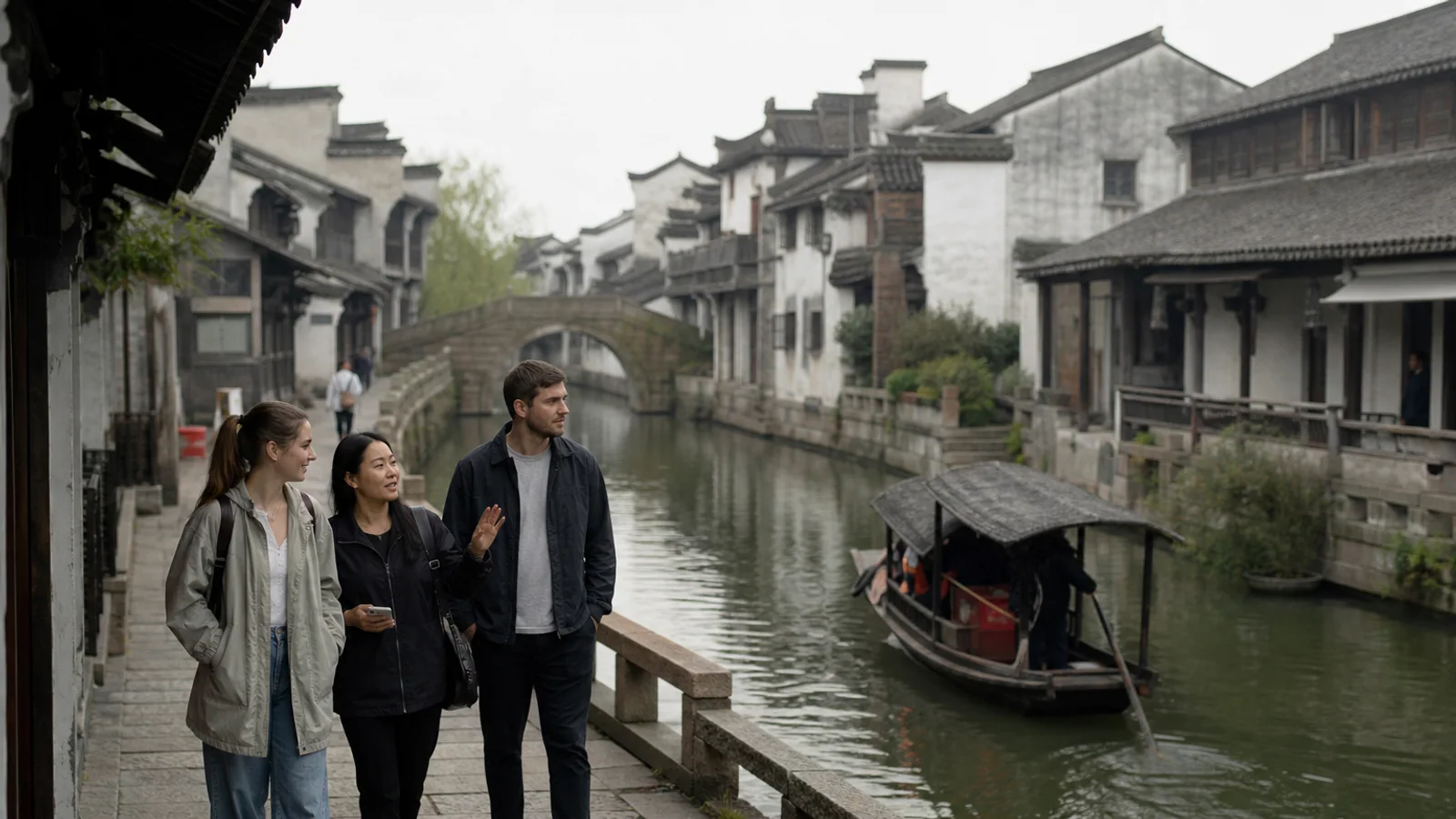 International travelers walking beside an old canal and black awning boat in Shaoxing