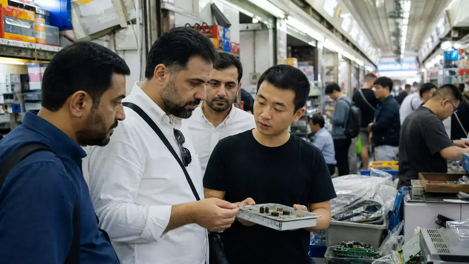 UAE technology buyers examining components in Huaqiangbei
