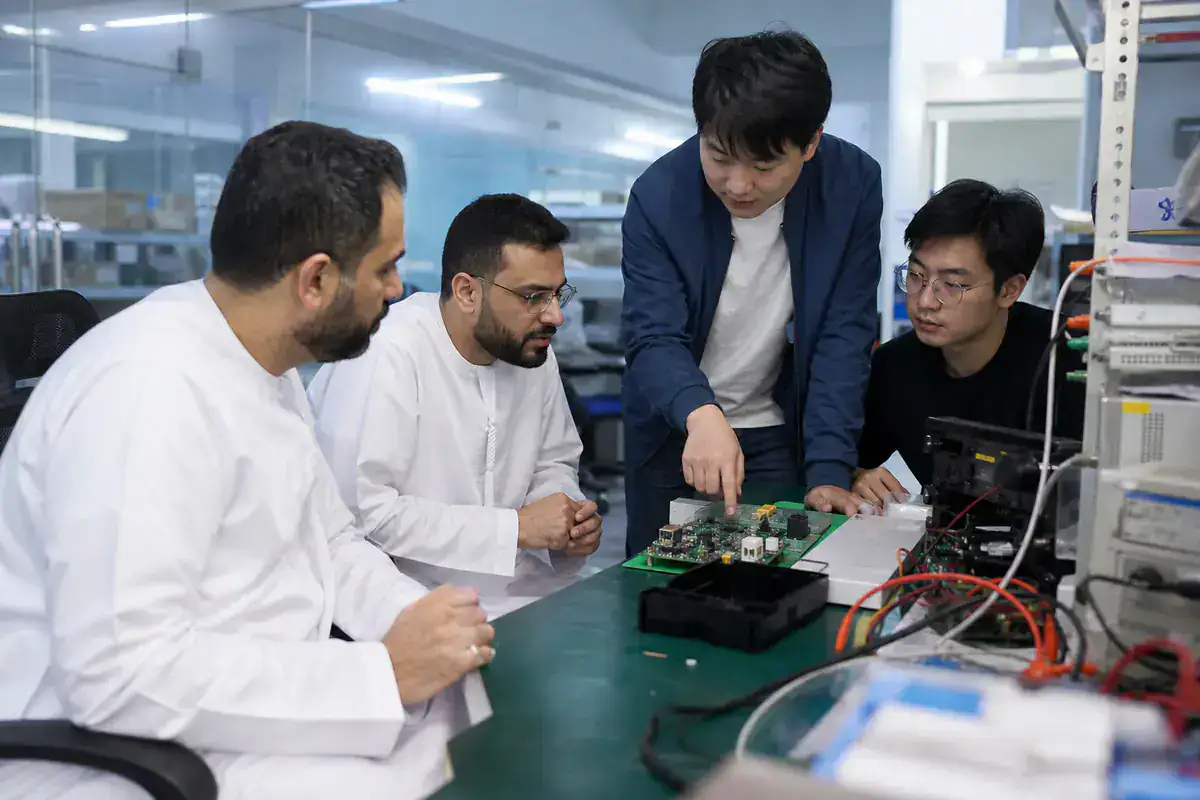 UAE founders reviewing an electronics prototype with Chinese engineers