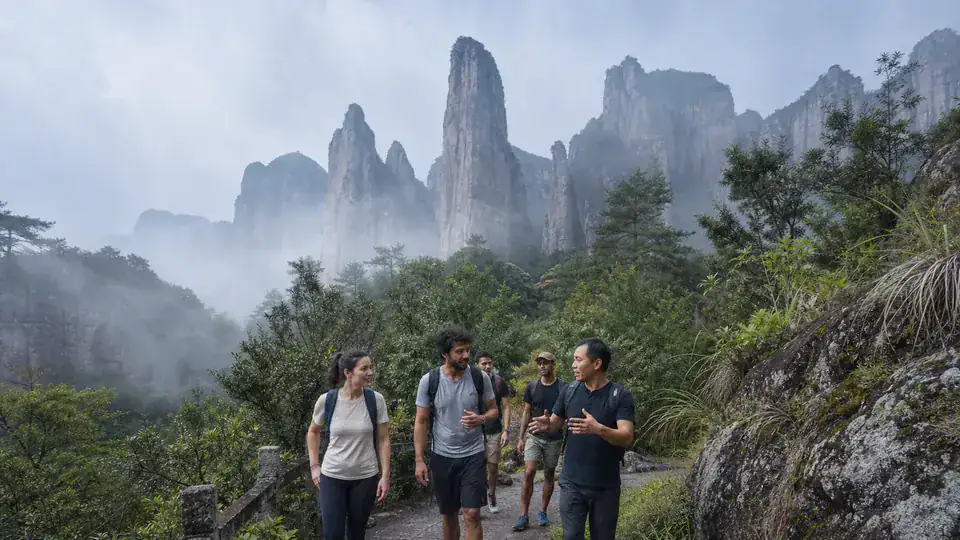 International travelers walking below the peaks of Lingfeng at Yandang Mountain