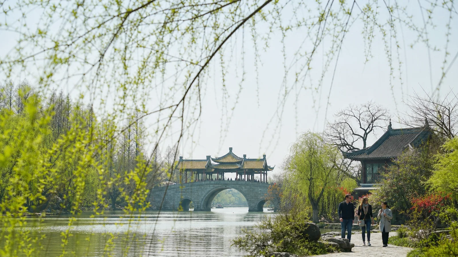International travelers exploring Slender West Lake in Yangzhou with a local guide