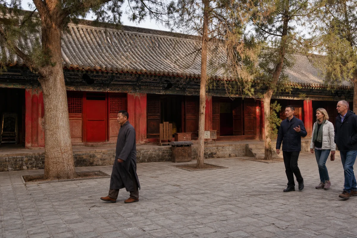 Travelers and a guide crossing the courtyard of Zhangye Great Buddha Temple