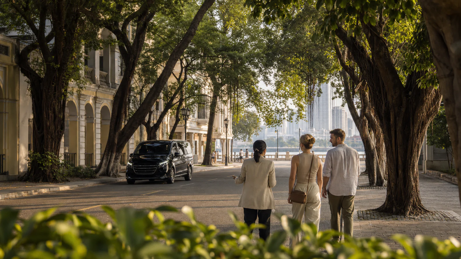 Private travelers walking with a guide beneath the banyan trees of Shamian Island in Guangzhou