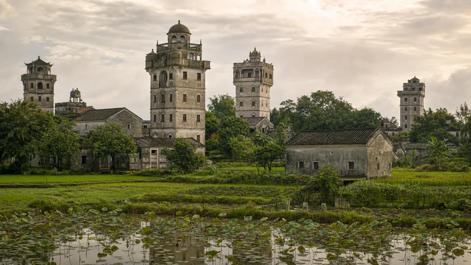 Kaiping diaolou rising above village homes, rice fields and lotus ponds in Guangdong