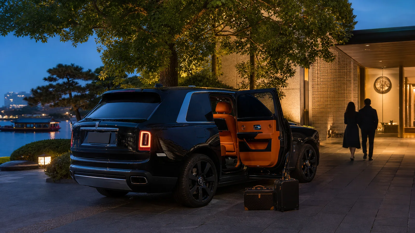 Black Rolls Royce Cullinan with orange leather interior outside a romantic Hangzhou lakeside hotel