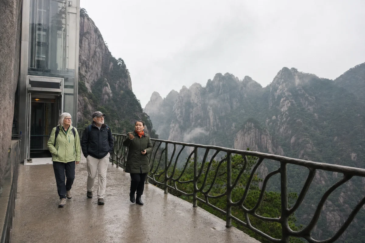 Older travelers and a guide leaving a mountain lift for a broad cliff walkway at Mangshan