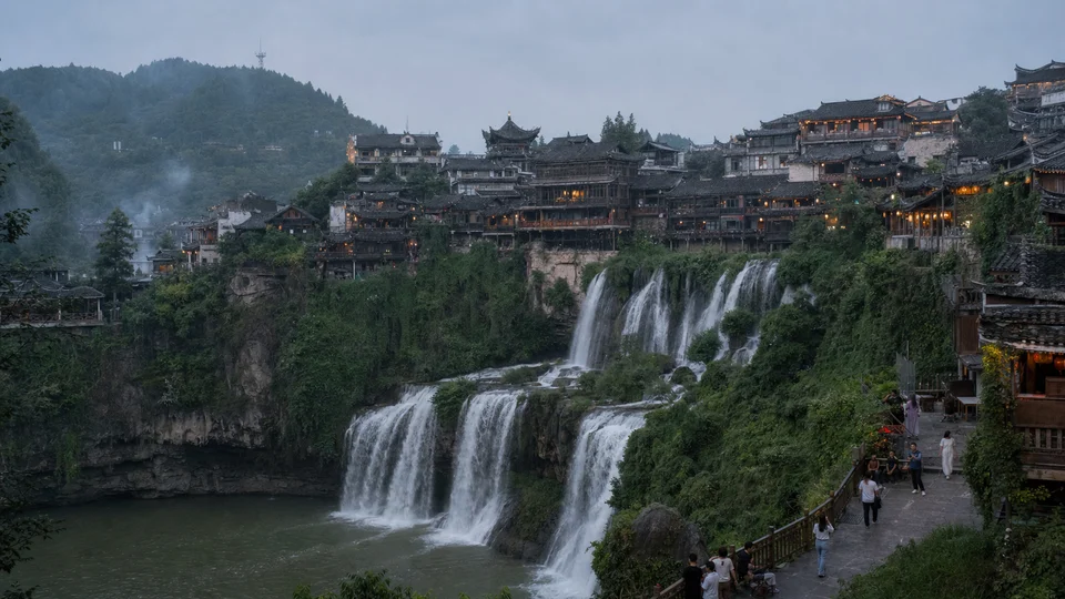 Furong Town houses and waterfall in western Hunan at dusk