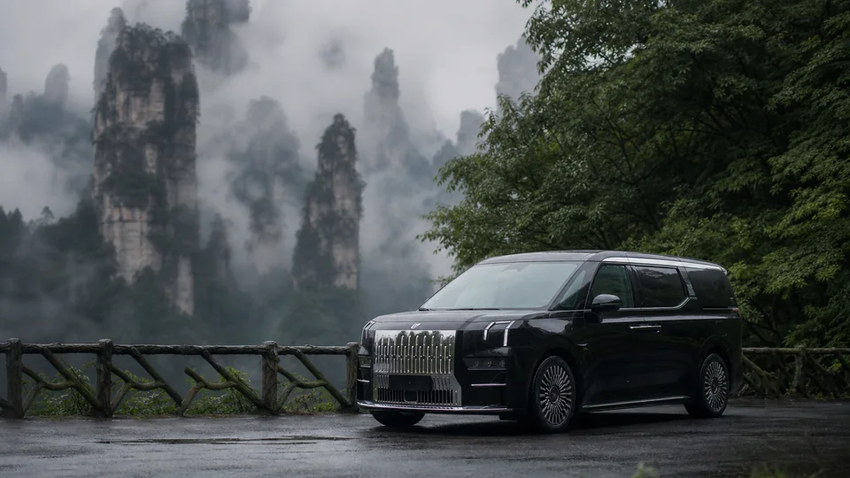 Black ZEEKR 009 on a misty forest road in Zhangjiajie